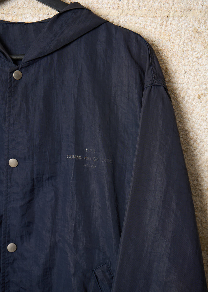 CDG HOMME BLUE SPELL OUT LOGO NYLON COACH JACKET 1989